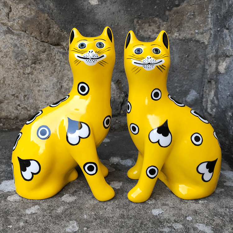 Two yellow cats are sitting next to each other