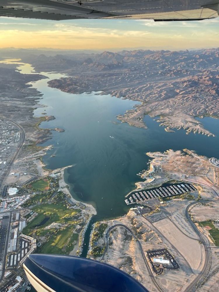 An aerial view of a large body of water surrounded by mountains.