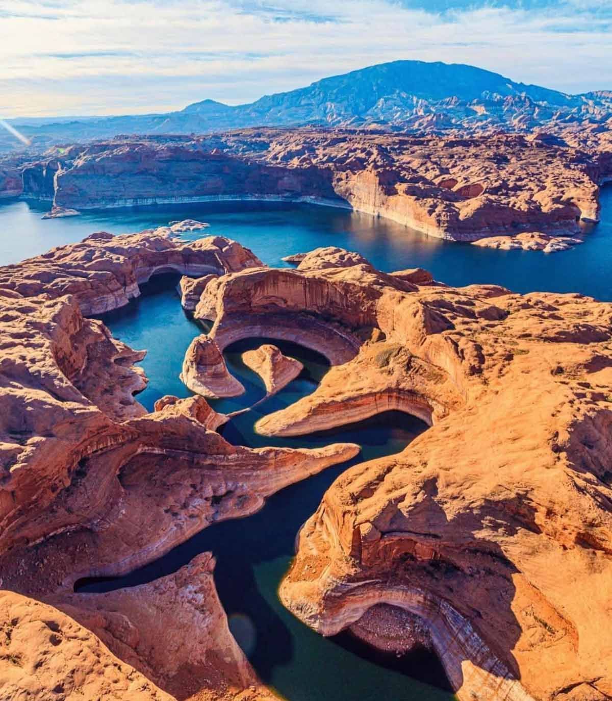 An aerial view of a lake surrounded by rocks and mountains.