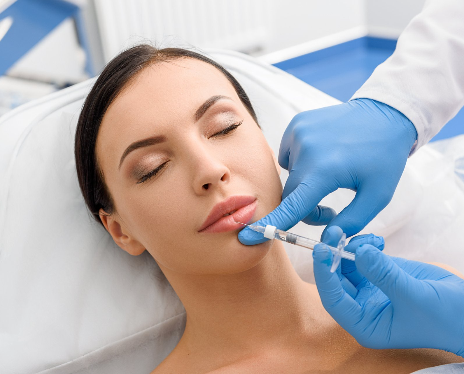 woman receiving lip filler injection