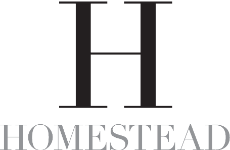 The word "HOMESTEAD" written in grey, serif capital letters below a large, black, serif capital letter "H."