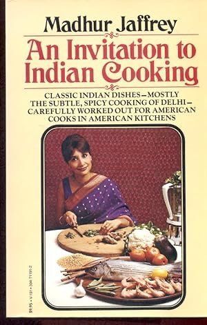 Book cover of Madhur Jaffrey’s “An Invitation to Indian Cooking” with a woman at a table of food.