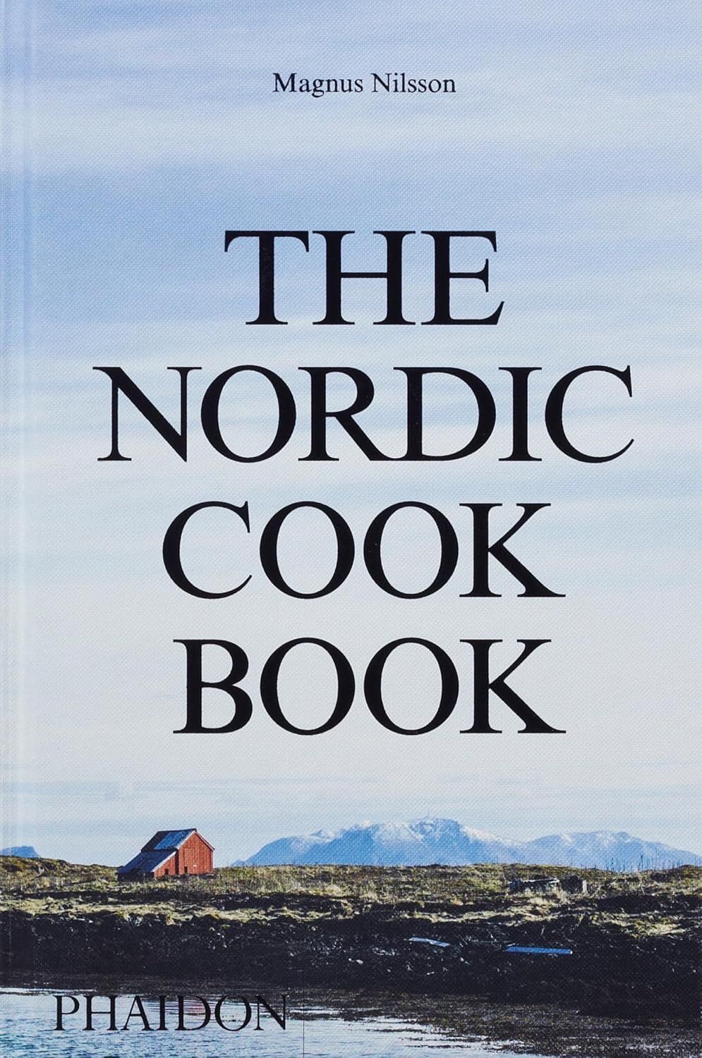 Book cover of “The Nordic Cook Book” with a blue sky and Arctic landscape background