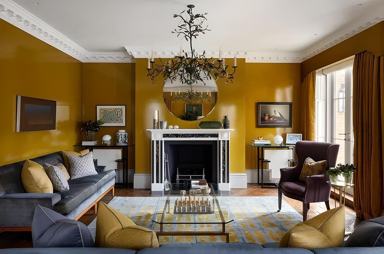 A living room with yellow walls and a fireplace