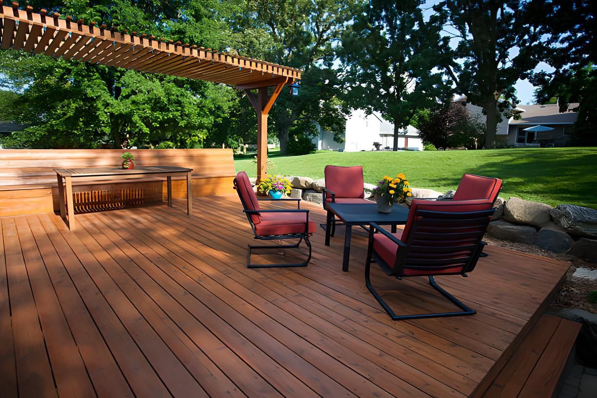 A wooden deck with chairs and a table under a pergola