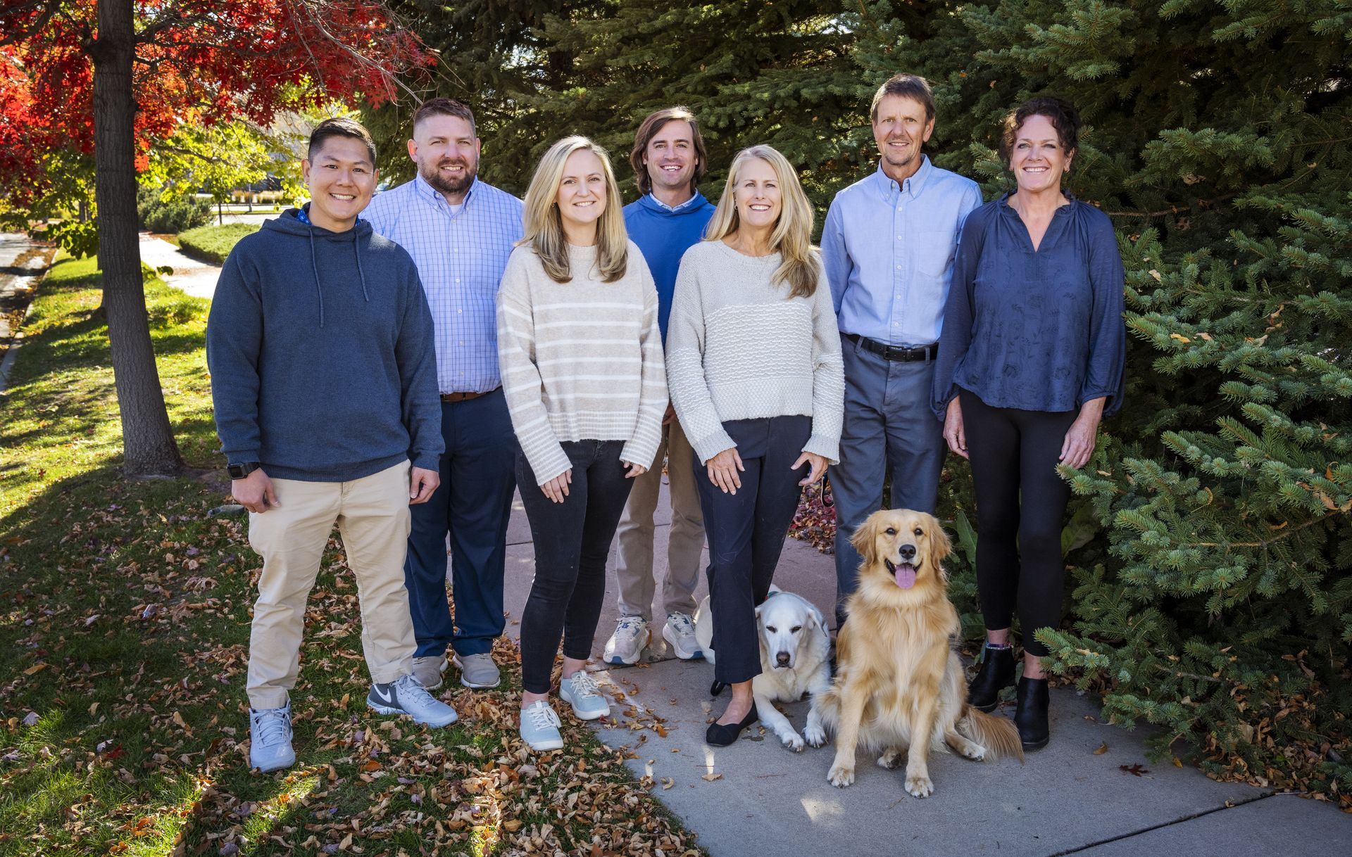 A group of people are posing for a picture on the beach.
