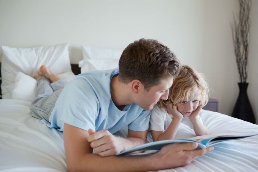 A Man And A Child Reading A Book Together — Cape Coral, FL — Dramko Diane Attorney At Law