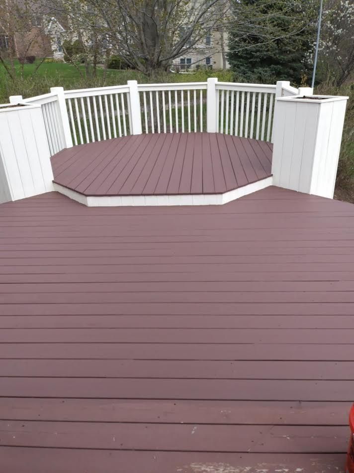 Brown composite deck with a small, raised, octagonal platform; white railing.