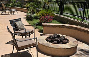 There is a fire pit in the middle of the patio.