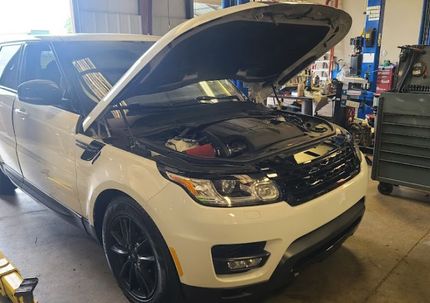A white Range Rover with opened hood in our auto repair shop in Sanford, NC | Integrated Automotive
