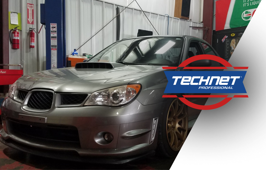 Silver Subaru WRX parked in a garage with a blue and red TechNet Professional logo overlay. | Integrated Automotive