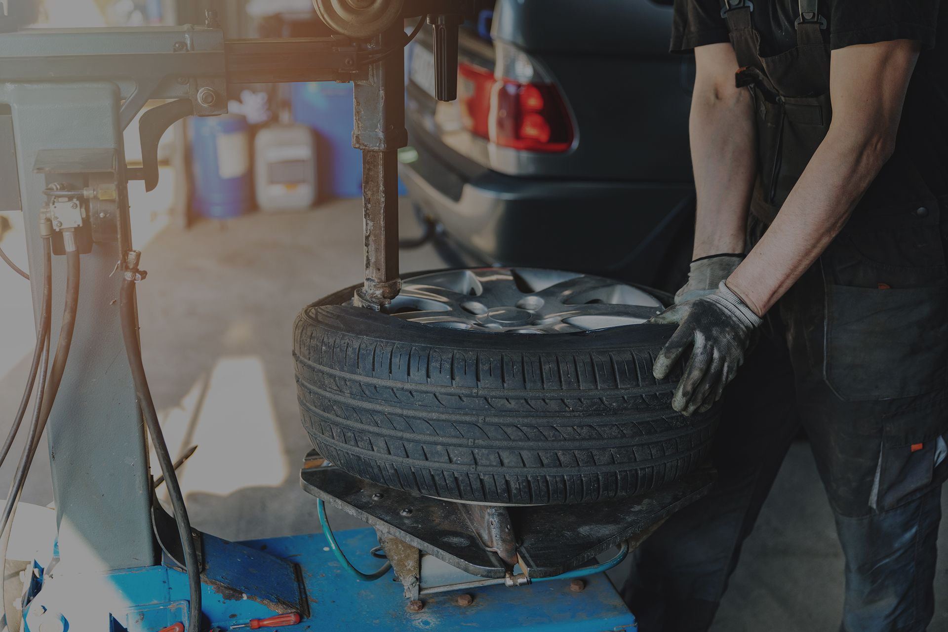 Mechanic removing a tire from a wheel with a machine in an auto shop. | Integrated Automotive