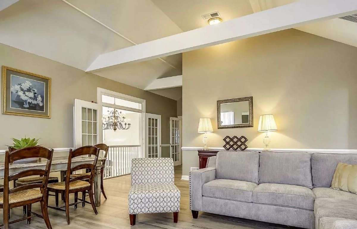 A living room with a couch , chair , table and chairs. | Brookeville, MD | Silo Falls