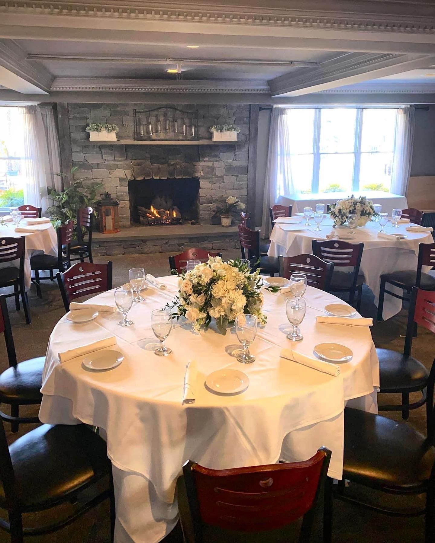 A restaurant with tables and chairs and a fireplace. | Brookeville, MD | Silo Falls