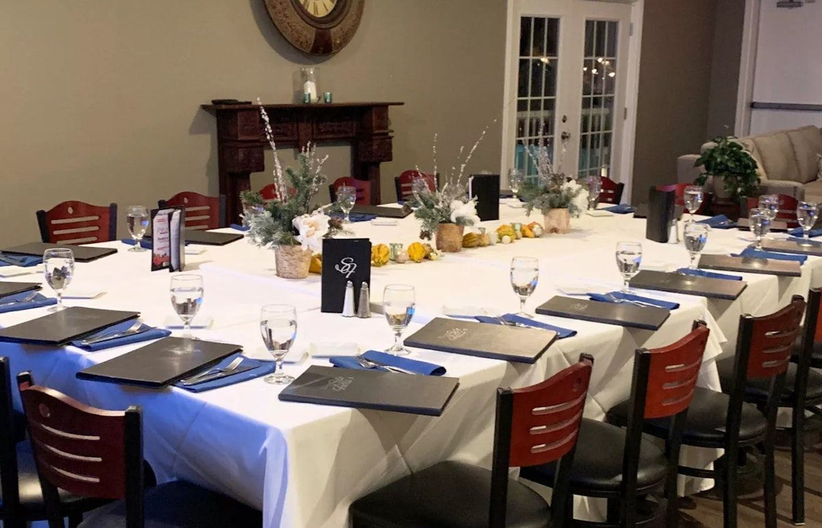 A long table with a white tablecloth and a clock on the wall. | Brookeville, MD | Silo Falls