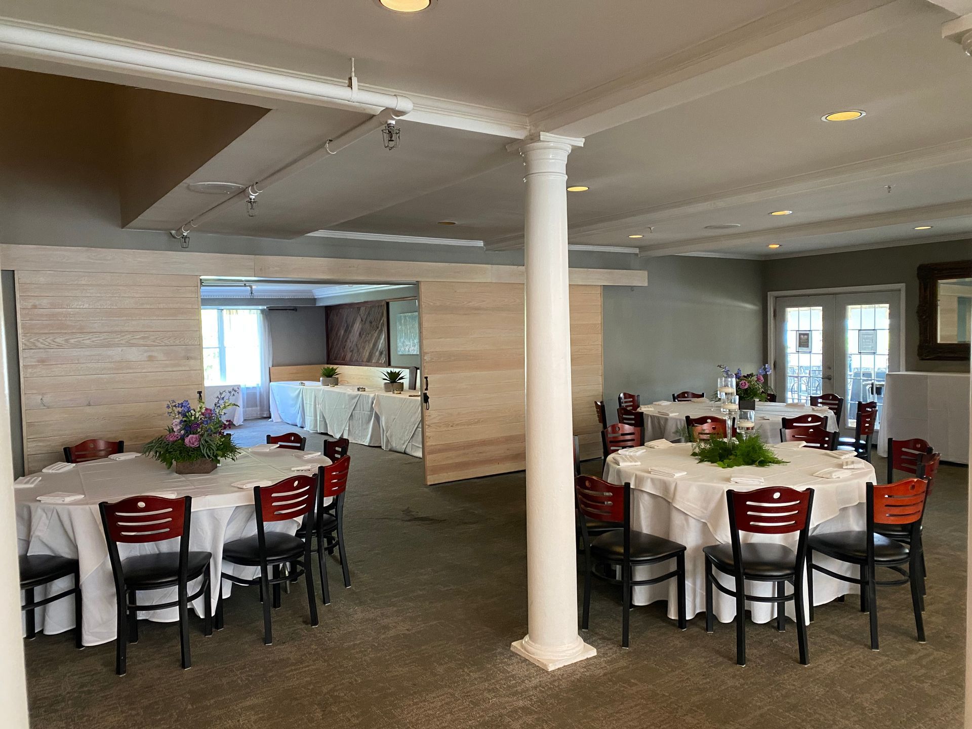 A large room with tables and chairs set up for a wedding reception. | Brookeville, MD | Silo Falls
