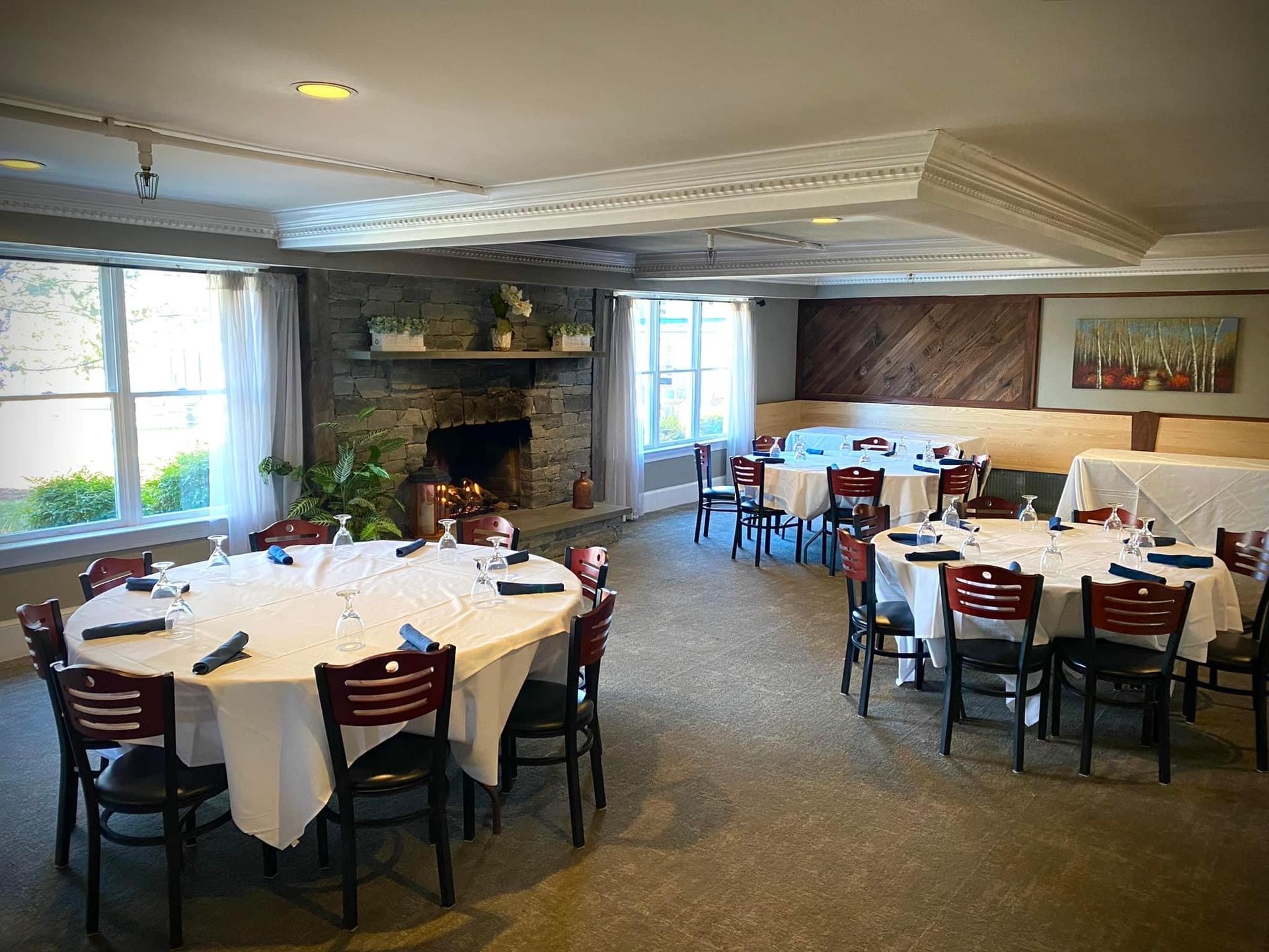 A large dining room with tables and chairs and a fireplace. | Brookeville, MD | Silo Falls