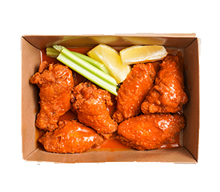 Box of fried chicken wings with celery and lemon wedges.