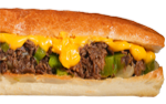 Cheesesteak sandwich with melted yellow cheese, green peppers, and steak on a long roll.