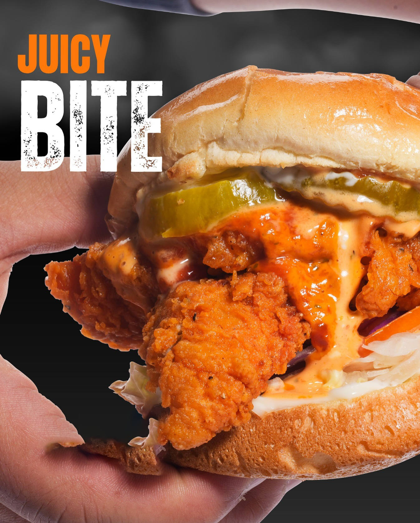 Close-up of a hand holding a fried chicken sandwich with pickles and sauce. Text reads 
