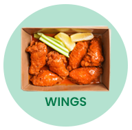 Box of fried chicken wings with celery and lemon garnish.