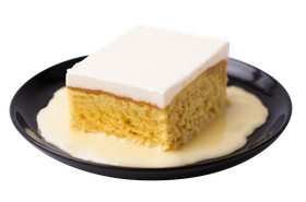 Tres leches cake slice on a black plate, covered in cream and soaked in milky sauce.