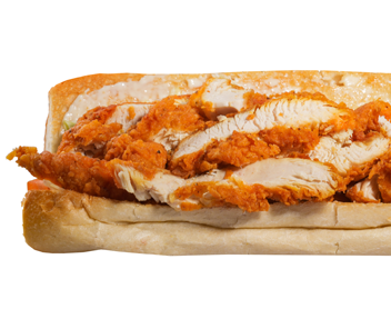 Fried chicken sandwich on white bread, close-up, orange breading, visible chicken slices.
