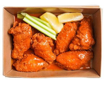 Buffalo chicken wings with celery and lemon wedges in a cardboard container.