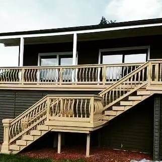 A house with a wooden deck and stairs leading up to it.