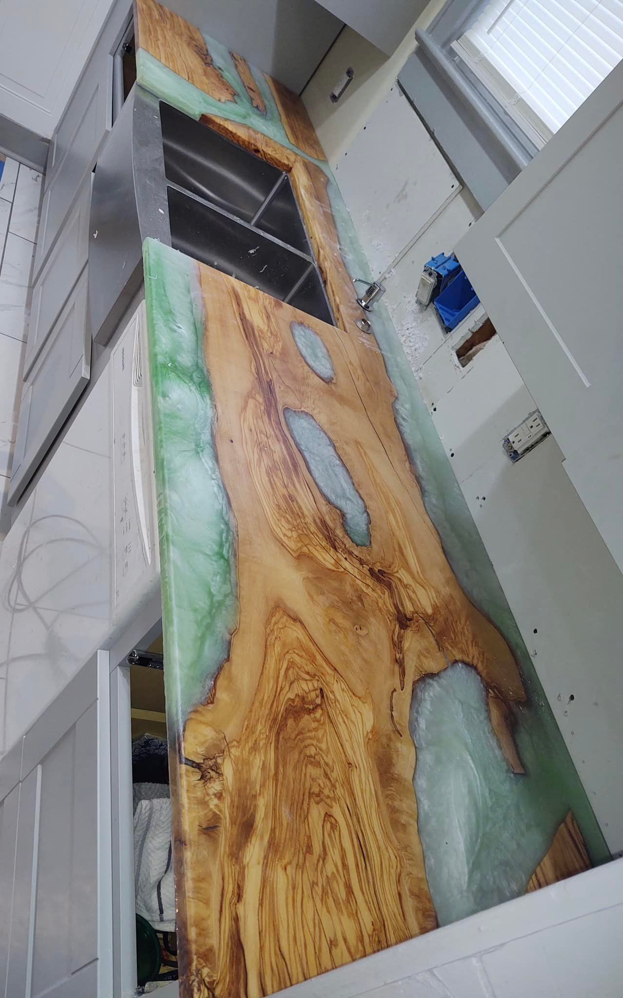 A kitchen with a wooden counter top and a sink.