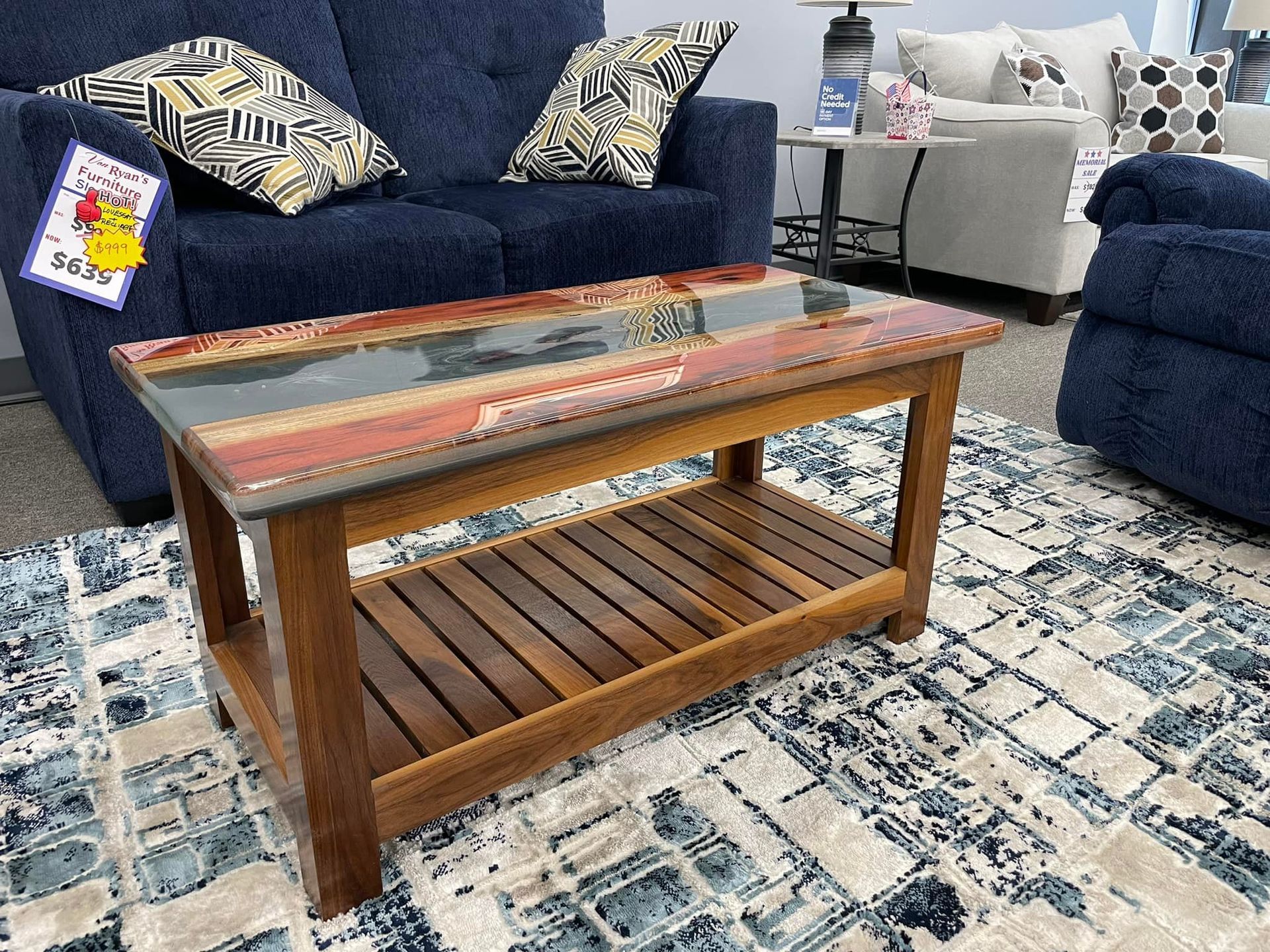 A coffee table is sitting on a rug in a living room next to a couch.