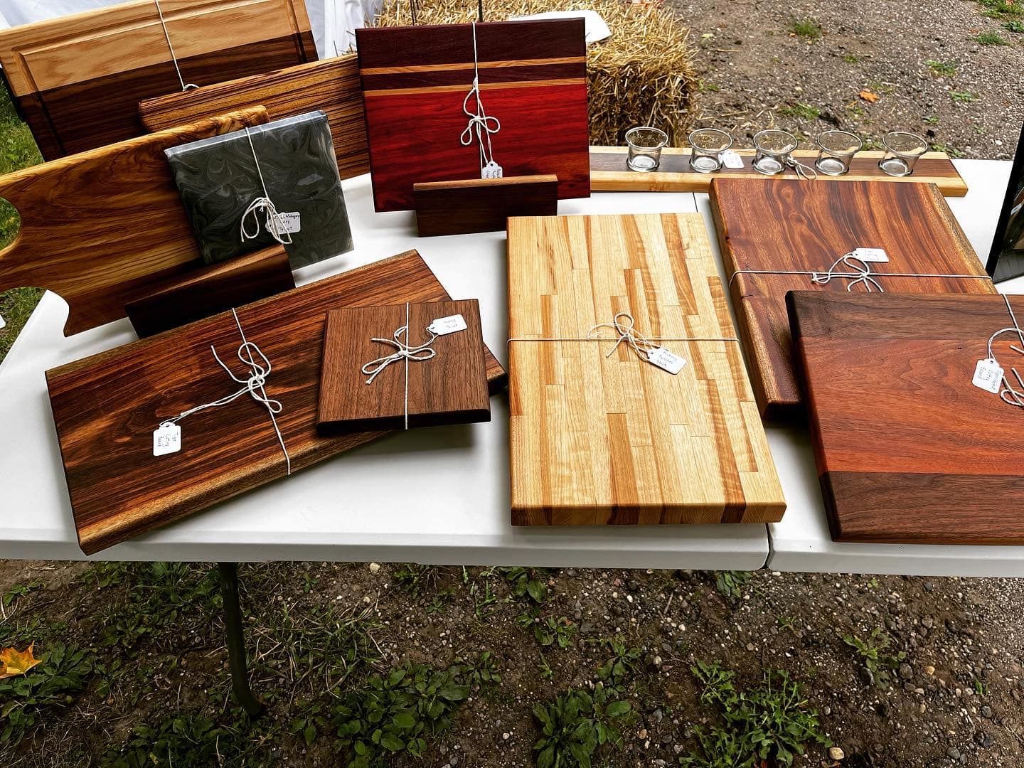 A table with a bunch of wooden cutting boards on it