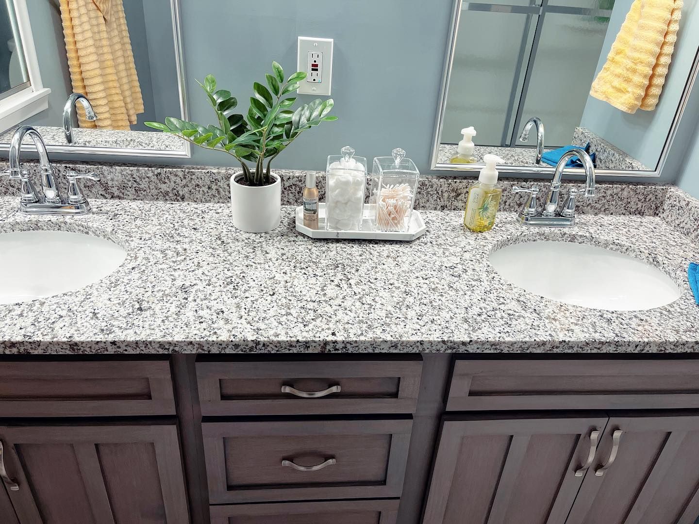 A bathroom with two sinks and a large mirror.