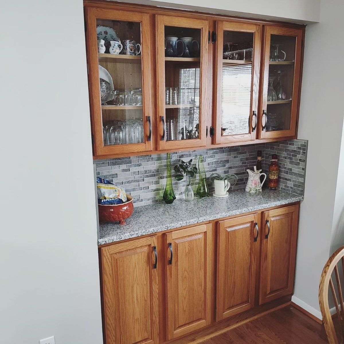 A kitchen with wooden cabinets and granite counter tops