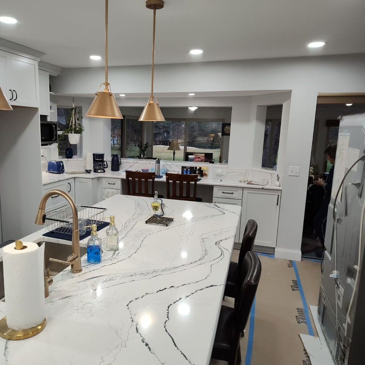 A kitchen with a large counter top and a sink.