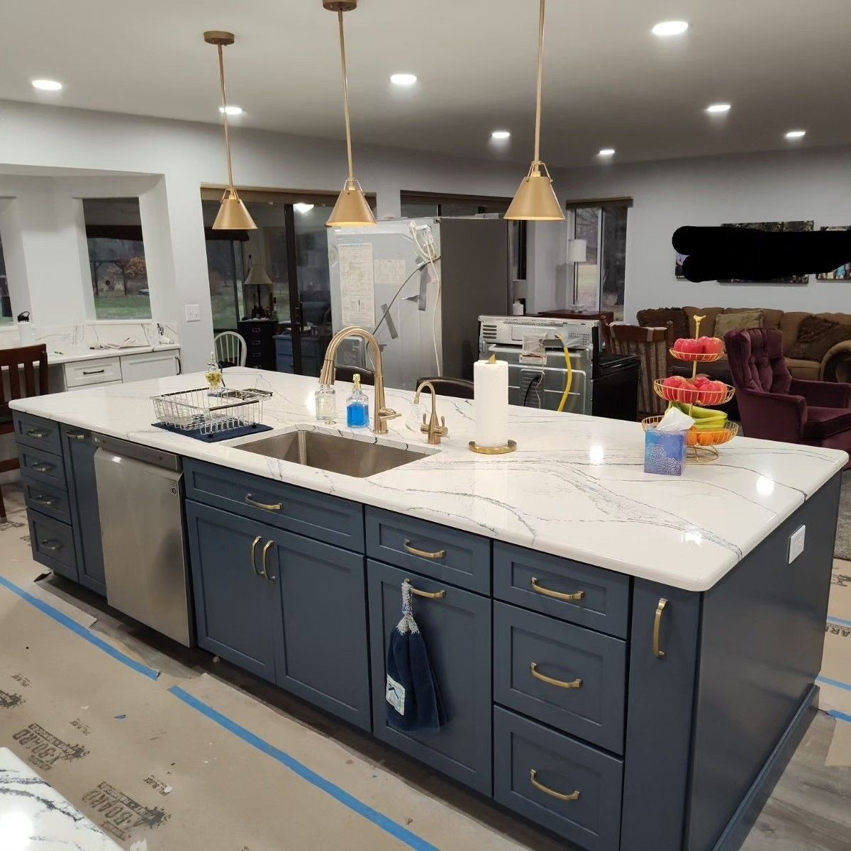 A kitchen with a large island and a sink