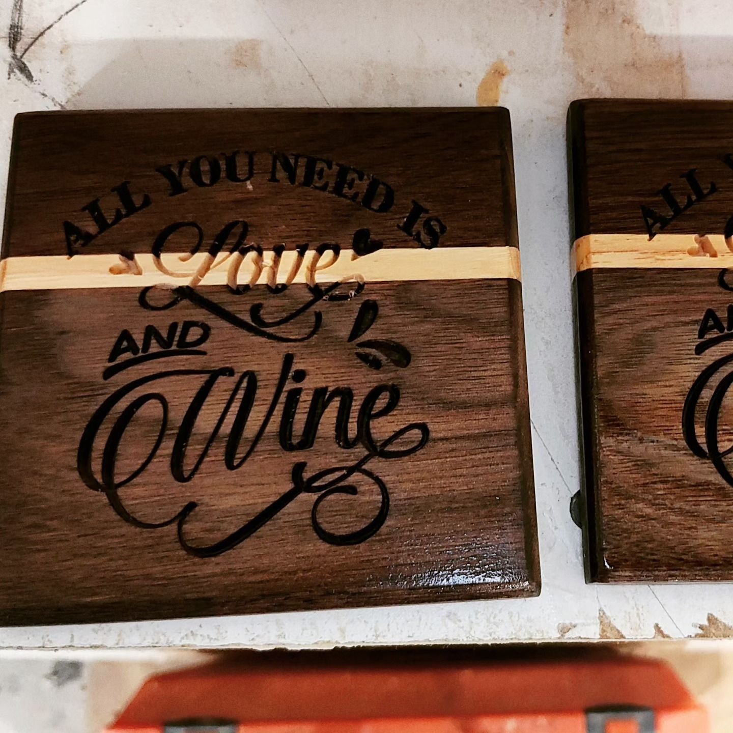 Two wooden coasters that say all you need is love and wine