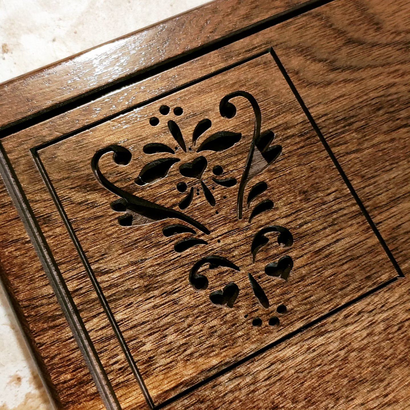 A wooden box with a floral design on it