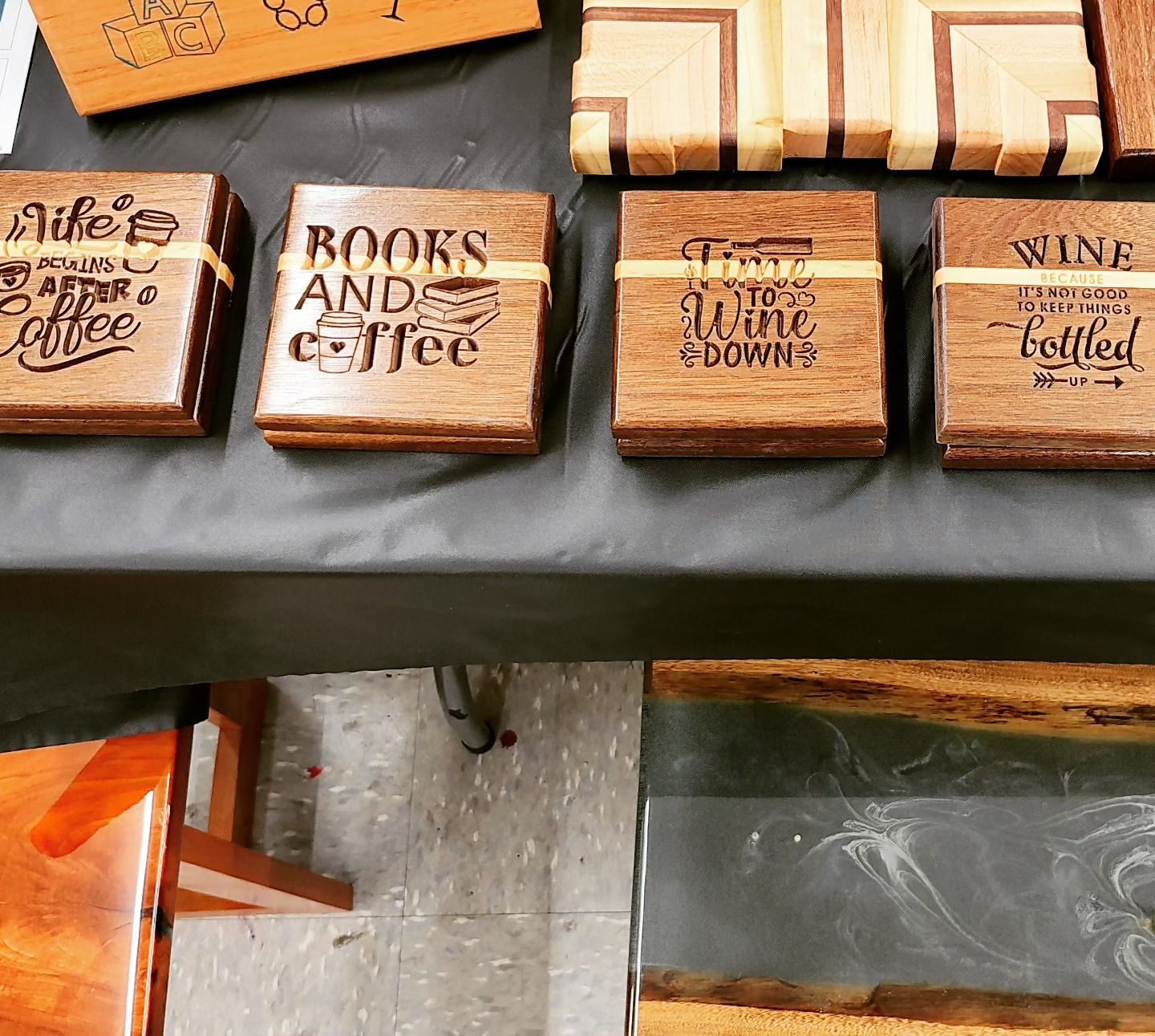 Wooden coasters on a table that say books and coffee