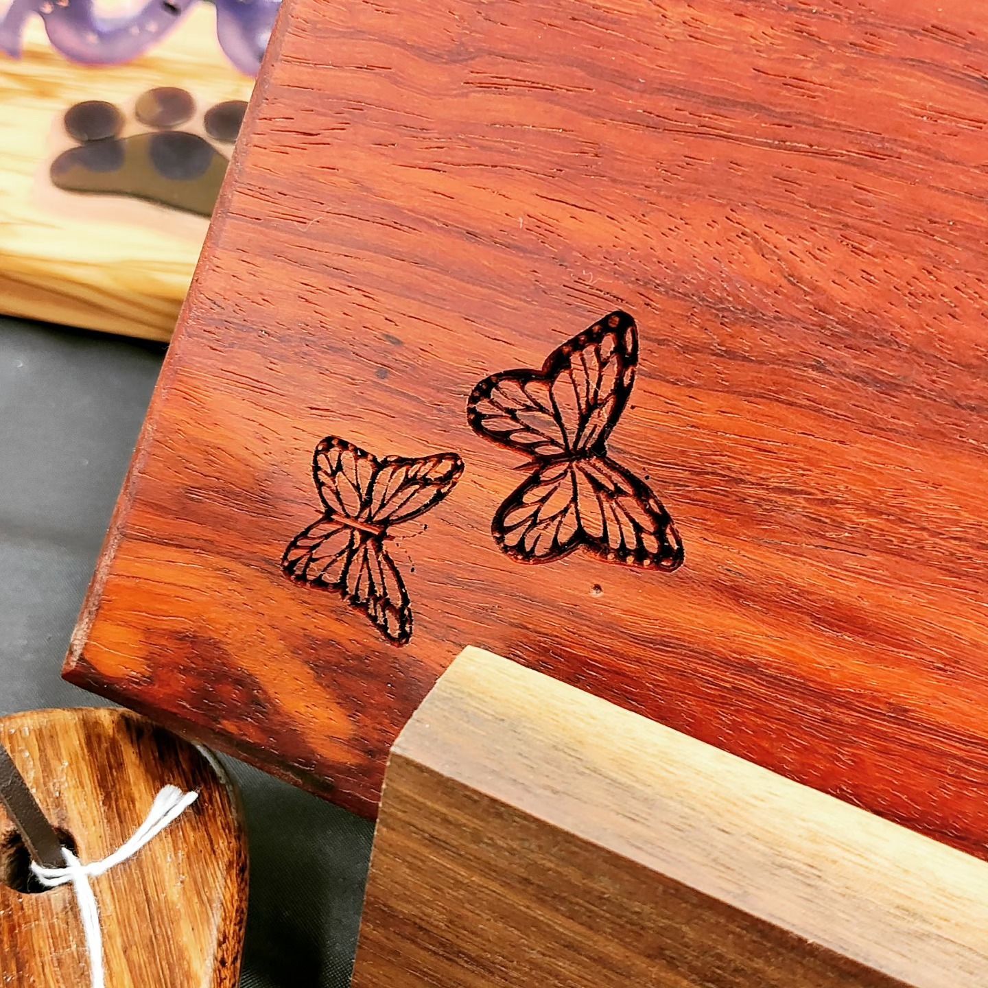 Two butterflies are engraved on a piece of wood