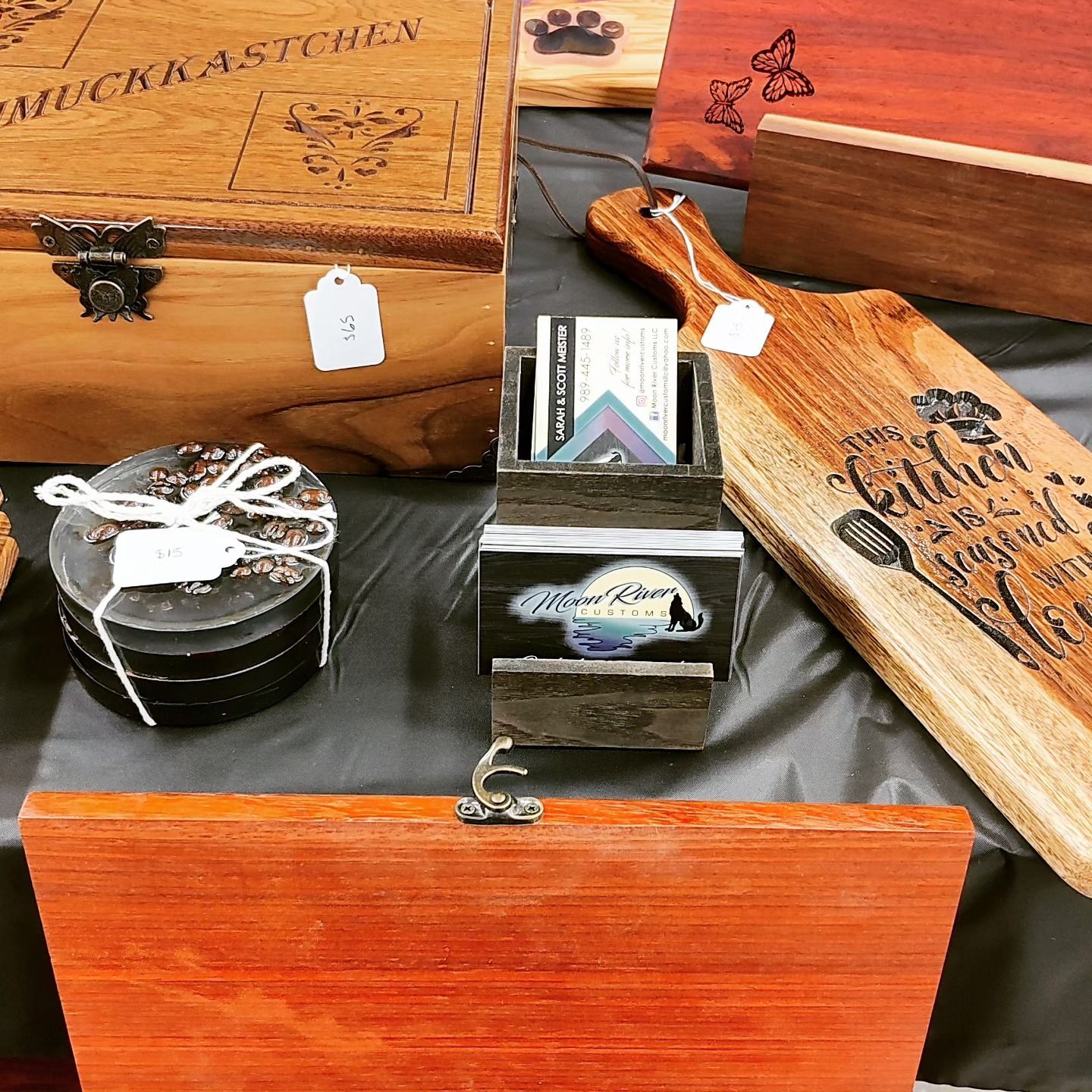 A table with wooden boxes and cutting boards on it