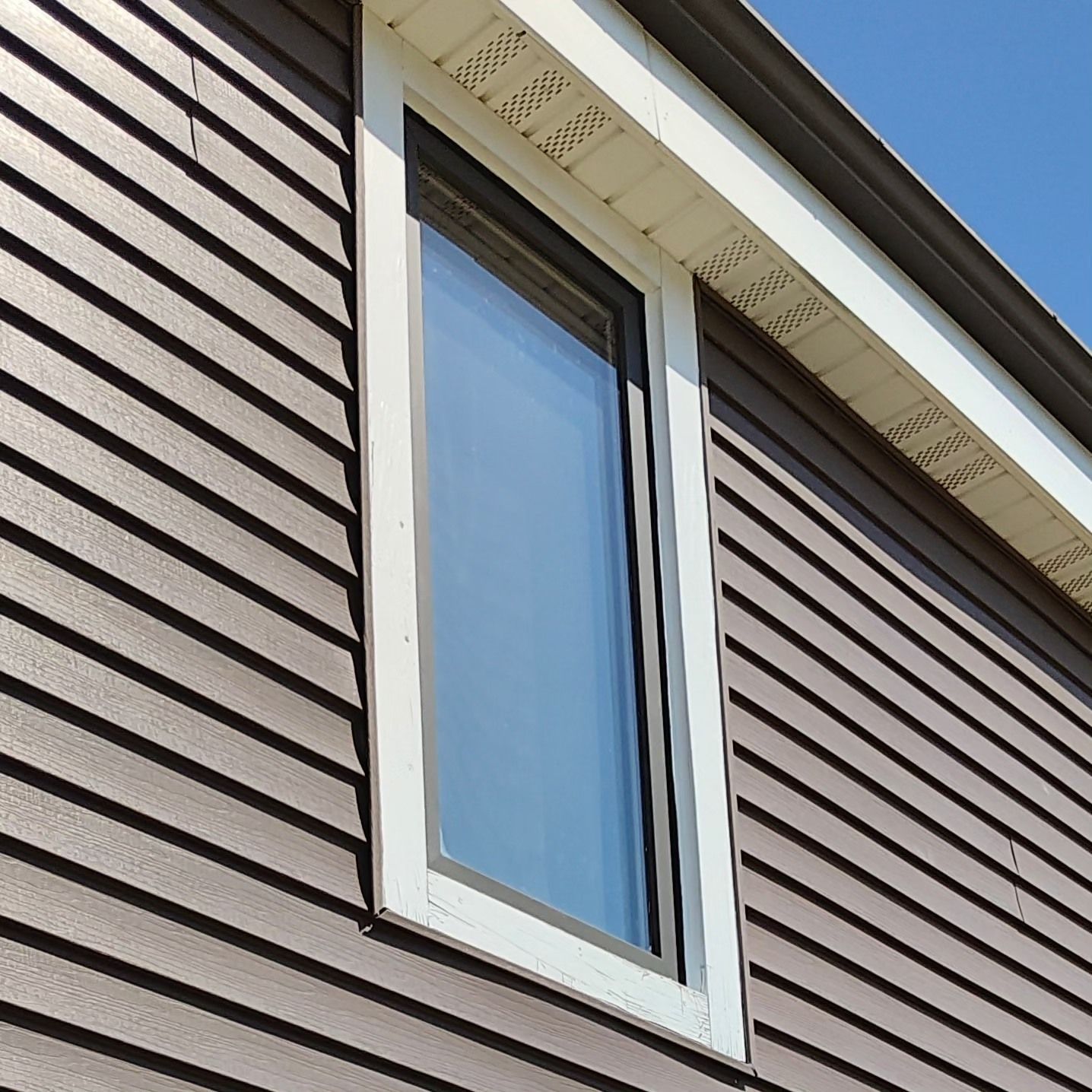 A close up of a window on the side of a house