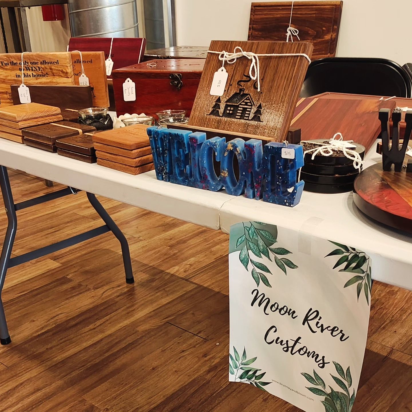 A table with a sign that says moon river customs on it