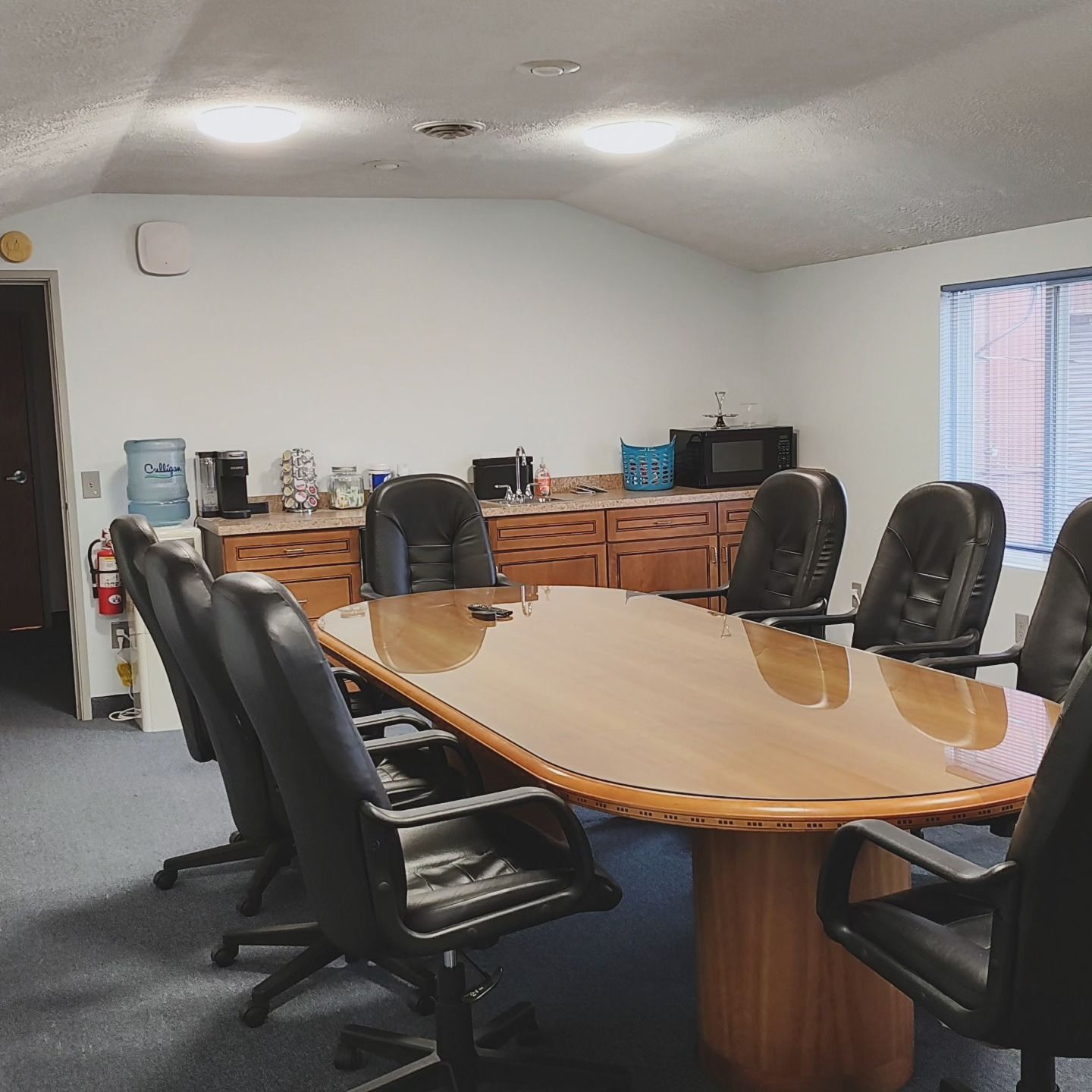 A conference room with a long table and chairs