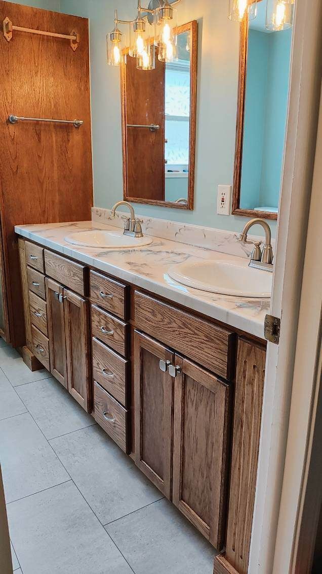 A bathroom with two sinks and two mirrors.