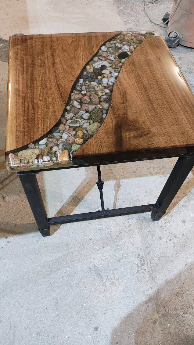 A wooden table with a river in the middle of it.