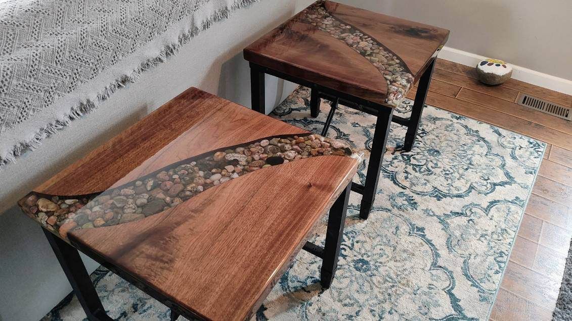 Two wooden tables are sitting on top of a rug in a room.