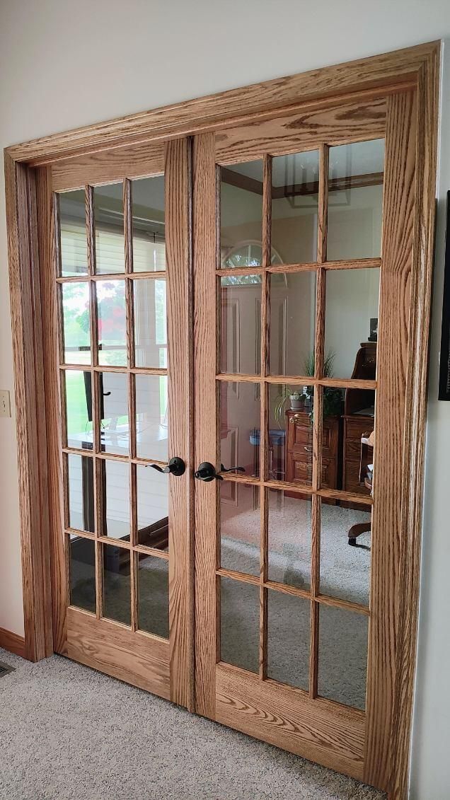 A pair of wooden sliding glass doors in a living room.