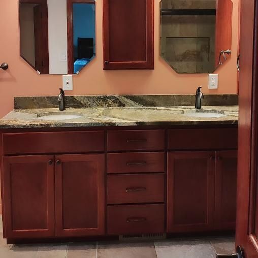 A bathroom with two sinks and two mirrors