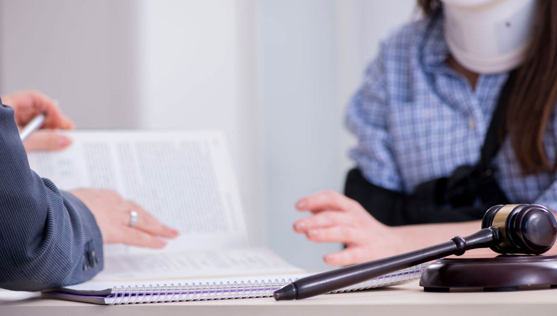 Injured woman visiting lawyer for advice on insurance